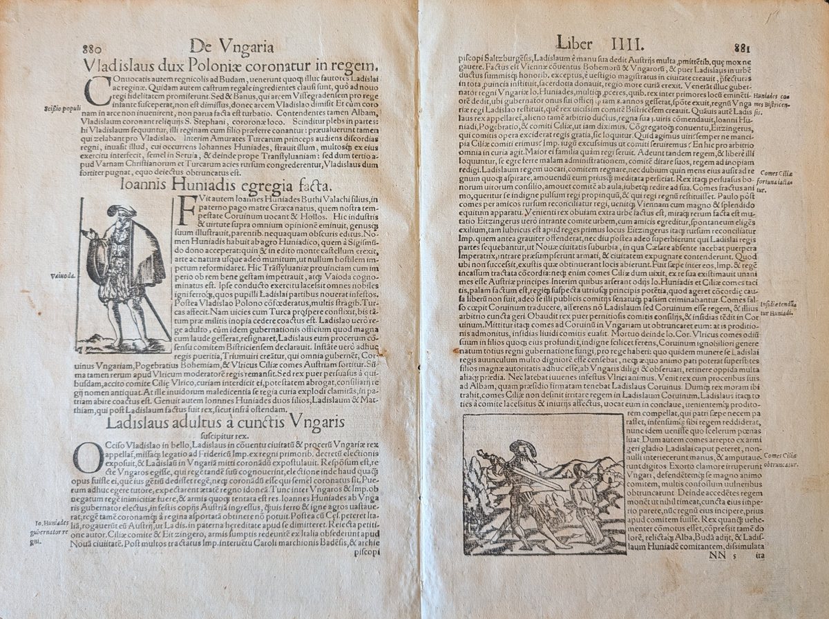 An opened pair of printed folio pages in Latin, headed De Vngaria and Liber IIII: dense roman type in a single column with marginal notes, a full-length woodcut of a standing figure labelled Vaivoda at the left, and at the lower right a woodcut of armed men cutting down a figure in a landscape.